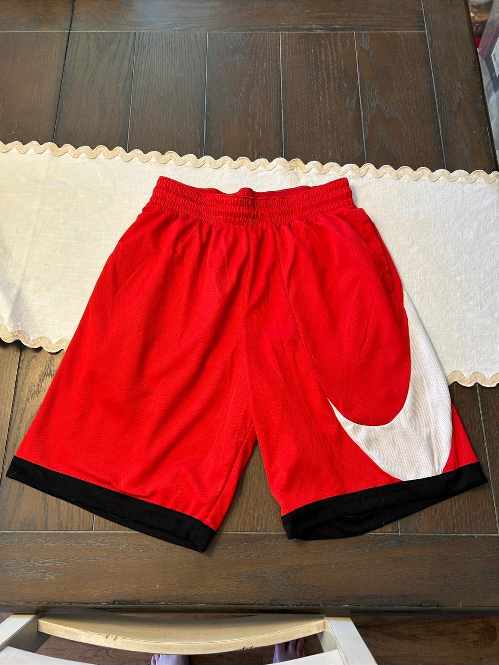 Nike Red Athletic Shorts with White Swoosh and Black Hem